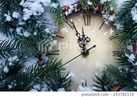 Vintage clock and fir tree branches in the snow. 133782119