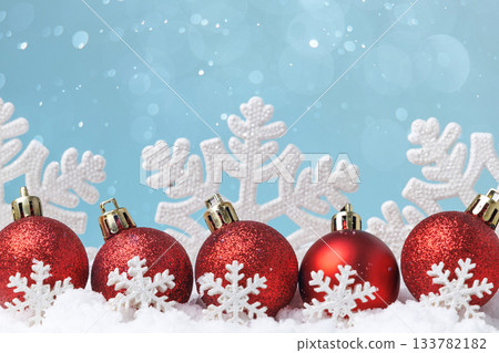 Red Christmas baubles with snowflake pattern on snow, copy space Red Christmas baubles with snowflake pattern on snow, copy space 133782182