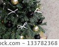 Christmas tree with white bows and black and gold ornaments 133782368