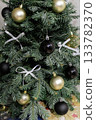 Close up of Christmas ornaments and white bows on a tree 133782370
