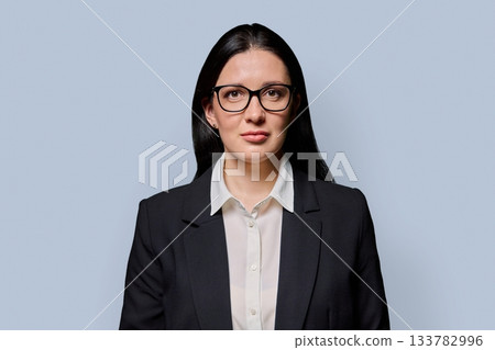 Portrait of serious middle-aged businesswoman in black jacket on light studio background Portrait of serious middle-aged businesswoman in black jacket on light studio background 133782996