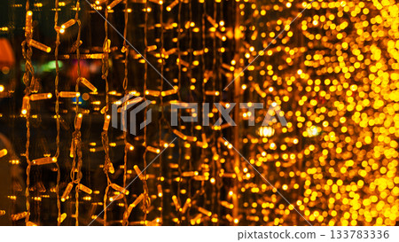 garland of light bulbs in a window display for Christmas, decorating shops and retail outlets for the beloved winter holiday garland of light bulbs in a window display for Christmas, decorating shops and retail outlets for the beloved winter holiday 133783336