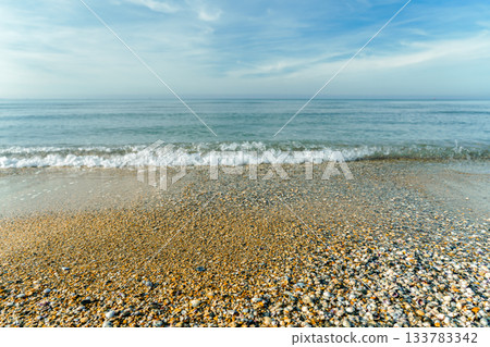shell beach and gentle surf on a clear, warm autumn day, beach walks and relaxation on a weekend shell beach and gentle surf on a clear, warm autumn day, beach walks and relaxation on a weekend 133783342