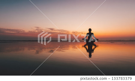 Silhouette Of Person Meditating At Sunset On Calm Reflective Beach With Peaceful Horizon Silhouette Of Person Meditating At Sunset On Calm Reflective Beach With Peaceful Horizon 133783379