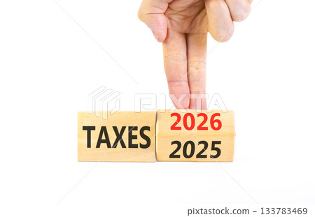 2026 taxes new year symbol. Concept words 2026 taxes on beautiful wooden blocks. Beautiful white paper background. Businessman's hand. Business and 2026 taxes new year concept. Copy space. 133783469
