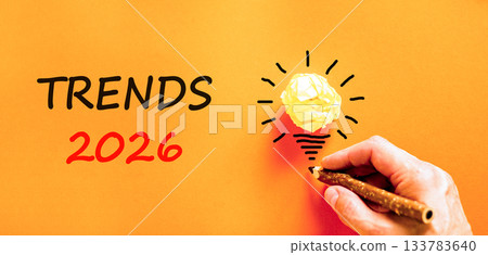 Trends 2026 new year symbol. Concept words Trends 2026 on beautiful orange paper. Beautiful orange paper background. Businessman's hand with pen. Business and Trends 2026 new year concept. Copy space. Trends 2026 new year symbol. Concept words Trends 2026 on beautiful orange paper. Beautiful orange paper background. Businessman's hand with pen. Business and Trends 2026 new year concept. Copy space. 133783640