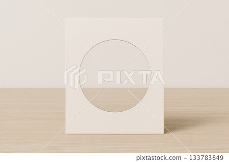 Cardboard frame with a round cutout on the table. Space for text. 133783849