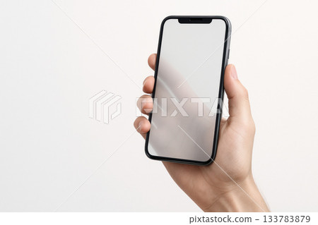 Hand holding smartphone with blank screen. Space for text. Hand holding smartphone with blank screen. Space for text. 133783879
