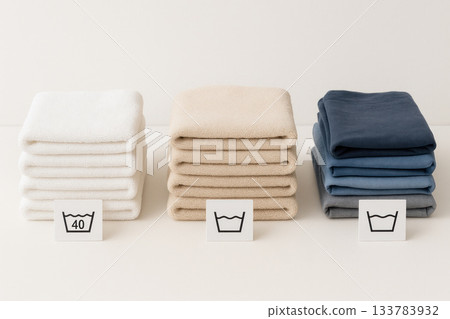 Folded colored towels with care icons. 133783932