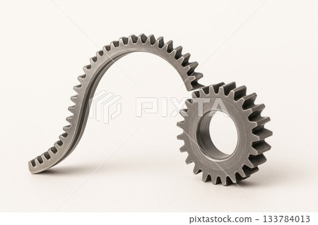 Curved and straight metal gears as a symbol of a non-standard solution. Space for text. 133784013