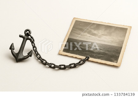 Anchor with chain holds vintage photo of the sea. Space for text. Anchor with chain holds vintage photo of the sea. Space for text. 133784139