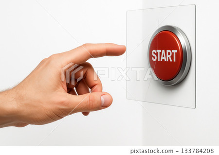 A hand reaches for the red START button behind the glass. Space for text. 133784208