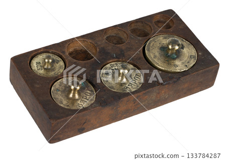 Vintage wooden box with scale weights set on white 133784287
