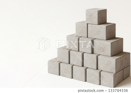 Concrete blocks in the shape of a pyramid on a light background. Space for text. Concrete blocks in the shape of a pyramid on a light background. Space for text. 133784336