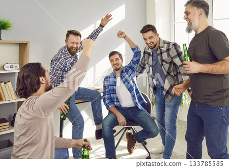 Group of happy male friends celebrating victory of favourite sport team 133785585