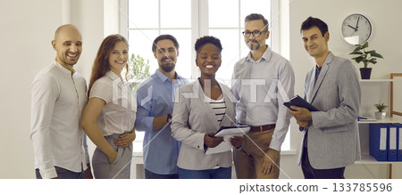 Team of happy smiling successful multiracial business people standing in the office 133785596