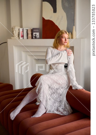 Contemplative caucasian woman planning on sofa - strategist Contemplative caucasian woman planning on sofa - strategist 133785823