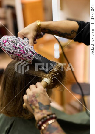 Hair educator demonstrating volumizing blowout technique Hair educator demonstrating volumizing blowout technique 133785843