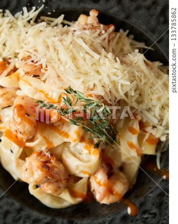 Closeup of gourmet lobster dish, Appetizing lobster pasta topped with Parmesan and fragrant thyme 133785862