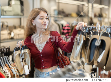 European woman chooses stylish ballet flats in the store European woman chooses stylish ballet flats in the store 133787350
