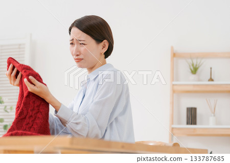 Woman confused by sweater Woman confused by sweater 133787685