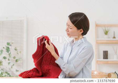 Woman confused by sweater 133787690