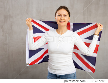 Adult cheerful woman holding flag of Great Britain 133787785
