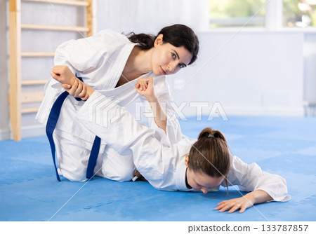 Two women training judo techniques in studio Two women training judo techniques in studio 133787857