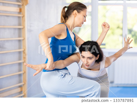Two women training self-defense techniques in studio Two women training self-defense techniques in studio 133787891