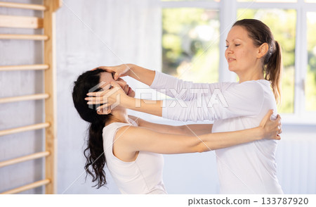 Two women training self-defense techniques in studio Two women training self-defense techniques in studio 133787920