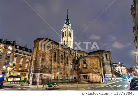 Church of Notre-Dame of Clignancourt in Paris, France. Historic Neo-Romanesque building stands on Place Jules Joffrin under a cloudy night sky Church of Notre-Dame of Clignancourt in Paris, France. Historic Neo-Romanesque building stands on Place Jules Joffrin under a cloudy night sky 133788045