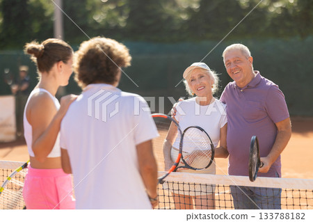 group of friends chatting after playing tennis group of friends chatting after playing tennis 133788182