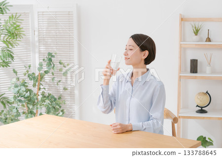 A woman in her 40s drinking water A woman in her 40s drinking water 133788645
