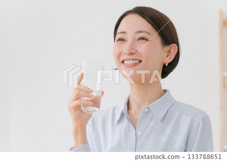 A woman in her 40s drinking water A woman in her 40s drinking water 133788651