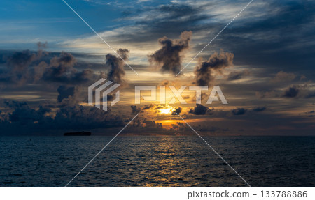 Ocean sunset on sea beach with sunset sky and seascape with ship. Seascape golden sunrise over the sea. Nature concept. Beautiful twilight. Early morning sunrise over sea. Mediterranean sea 133788886