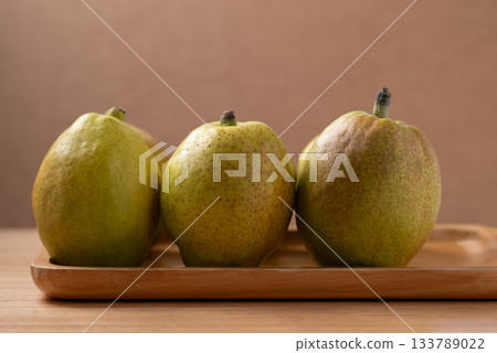 Fresh pear on wooden background 133789022