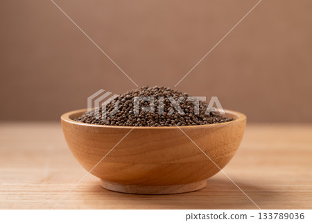 Dried perilla seed in a bowl on wooden background Dried perilla seed in a bowl on wooden background 133789036