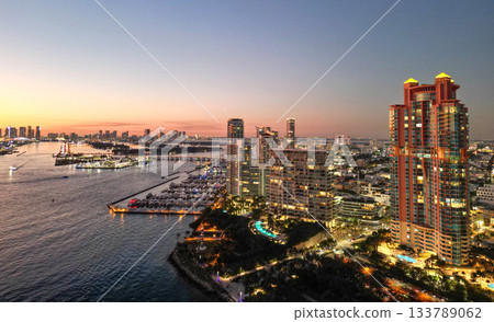 Marina Bay filled with vessels and yacht in Miami. Summer vacation scene with yachts by the oceanfront. Skyline with yachts in Miami. Florida coastline from above with boats. Boat trip in the Miami. 133789062