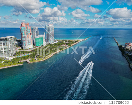 Aerial view of boats on turquoise waters in Miami. Yacht retreat in Miami. Cityscape with sailing vessels in Miami. Aerial view of boats on turquoise waters in Miami. Yacht retreat in Miami. Cityscape with sailing vessels in Miami. 133789063