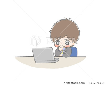 A male office worker thinking in front of a computer 133789338