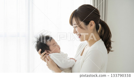 A mother holding a baby 133790338