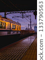 An express train arriving at a station at dusk 133790563