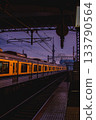 An express train arriving at a station at dusk 133790564