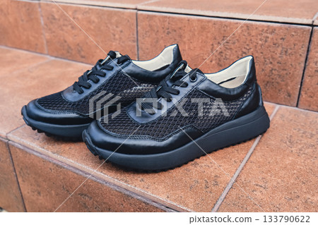 Elegant black leather womens shoes blank product for branding displayed. New casual female sneakers no-brand footwear e-commerce. No logo product 133790622