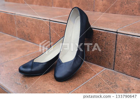 Elegant black leather womens shoes displayed. New black leather female shoes with glossy finish, perfect for style magazines footwear ads and modern elegant fashion e-commerce layouts. No logo Elegant black leather womens shoes displayed. New black leather female shoes with glossy finish, perfect for style magazines footwear ads and modern elegant fashion e-commerce layouts. No logo 133790647