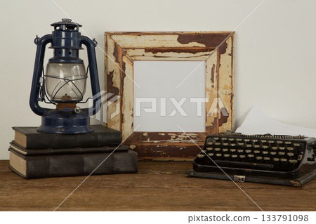 Photo frame, lantern and typewriter on table Photo frame, lantern and typewriter on table 133791098