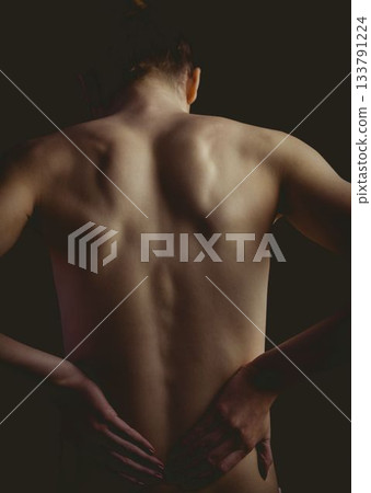 Lighting is highlighting female back and shoulders in 3D render over dark backdrop Lighting is highlighting female back and shoulders in 3D render over dark backdrop 133791224