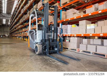 Forklift by rack in factory 133791284