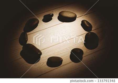 Pebbles on hardwood floor Pebbles on hardwood floor 133791348