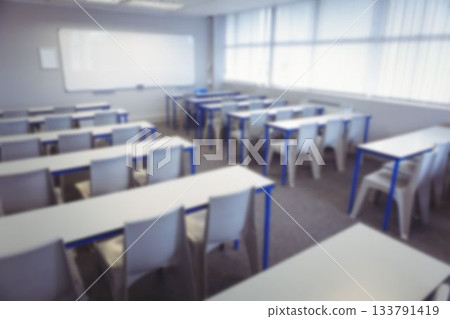 Desk and chairs arranged in classroom 133791419
